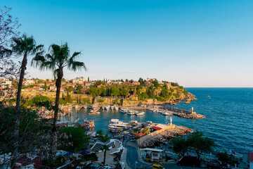 Fototapeta premium View from a height of the harbor near the old town of Kaleichi in the Turkish city of Antalya. Old port in Antalya with many ships and boats. Popular tourist place in Anatalya.