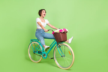Full length photo of cute adorable woman dressed white blouse speed riding cycle transport isolated green color background