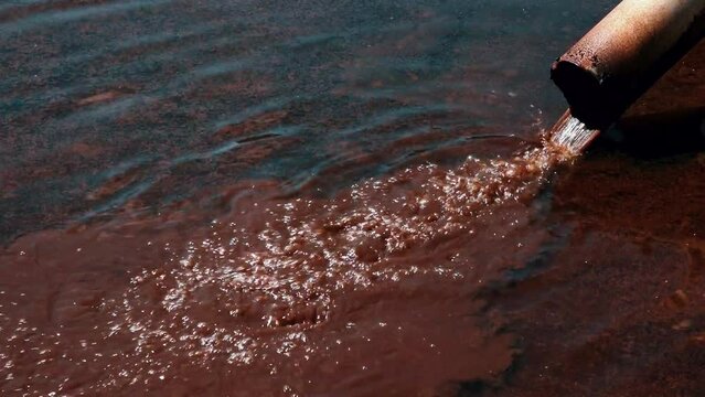 Water pollution in nature. Purification flows into the dirty. Pollution of the environment and water bodies. Ecological disaster. Dirty water flows from the pipe. Aquatic pollution.