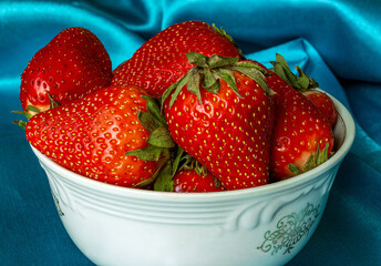 Fresh strawberries in a white plate. Close-up.