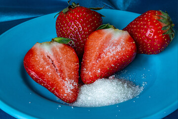Fresh strawberries with sugar on a plate