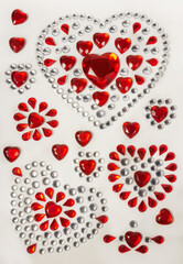 Romantic stickers for Valentine's Day: red crystalline hearts, red and silver rhinestones. Love and romantic concept.