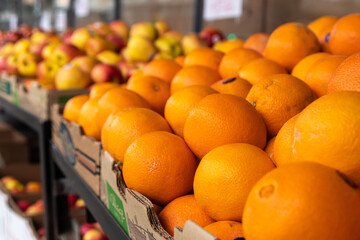 A close-up of oranges packed in a box at a fruit store that facing the street, Canada.