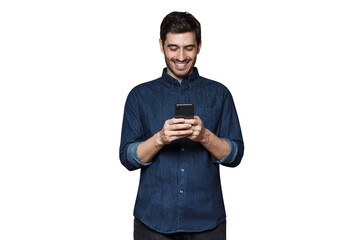 Young man smiling and laughing as he is browsing Internet or communicating via phone - 607941054