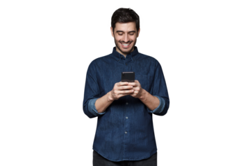 Young man smiling and laughing as he is browsing Internet or communicating via phone