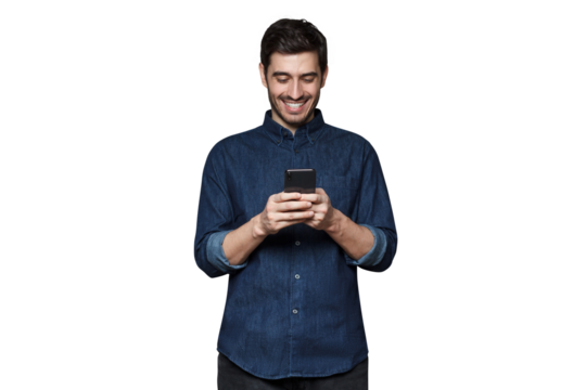 Young man smiling and laughing as he is browsing Internet or communicating via phone