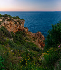 Coast of the Mediterranean Sea. Rock in the Turkish city of Antalya. Evening in Antalya.