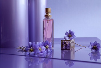 Delicate aromas of summer: blue flowers, a bottle of toilet water on a pastel background, space for...