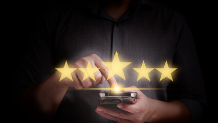 Close up man hand using smart phone and give five star symbol to increase rating of product and service concept, Customer service experience and business satisfaction survey.