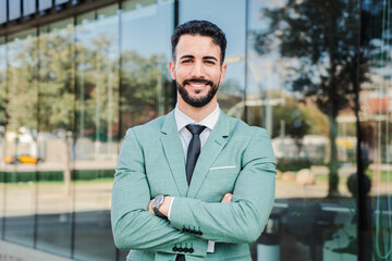 Handsome crossed arms business man executive looking at camera. Folded ambitious businessperson...