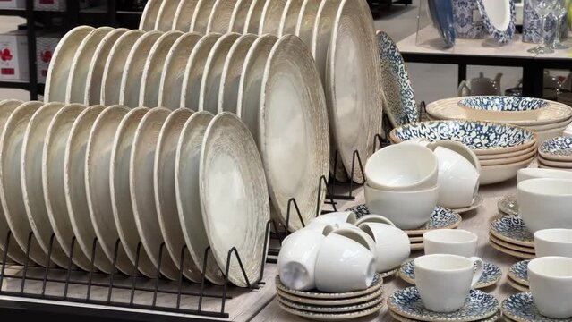 New plates, tea sets and other utensils are in the crockery store or tableware shop