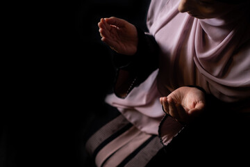 Muslim girly praying in house, reading holy Quran
