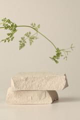 Stones and leaf platform podium on beige light background. Minimal empty display product...