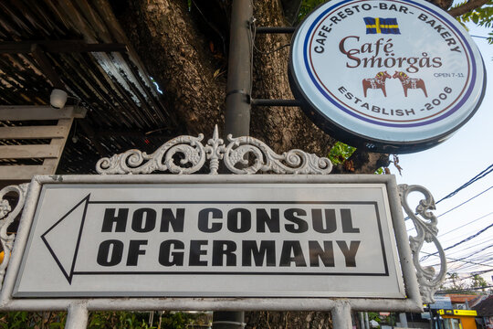 Sanur, Bali, Indonesia  A sign for the Honorary Consul of Germany and a Swedish bakery.