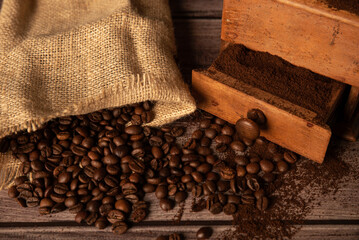 coffee beans scattered next to grinder