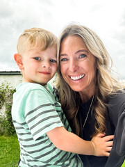 parent and child smiling at the camera