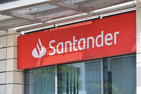 Santander bank signage, logo, symbol on the facade of Santander bank branch. WARSAW, POLAND - MAY 21, 2023
