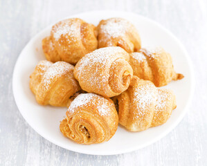 Fresh croissants on white plate