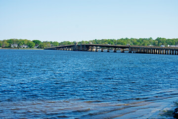 View across the blue waters of the Navesink River at the Oceanic Bridge and the town of Rumson, New Jersey, on a sunny day -02