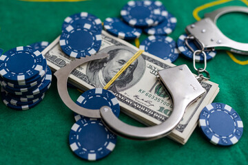 Poker playing chips with card and dollar banknoteson a casino green table. Online gambling. Texas