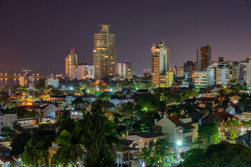 Obraz premium Dramatic night with many clouds in the city of Posadas, Argentina. Long exposure night photography.