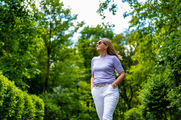 Beautiful woman walking in city park
