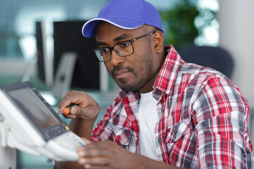 a handyman repairs a printer