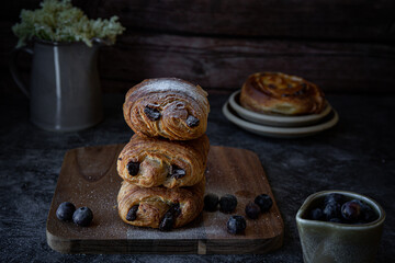 Freshly baked pain au chocolate on dark background