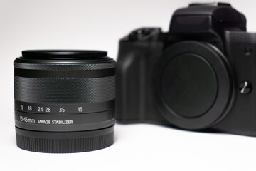 Photo camera body with zoom lens on white background. Media technology and photography concept, photography equipment