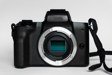 Photo camera body with zoom lens on white background. Media technology and photography concept, photography equipment