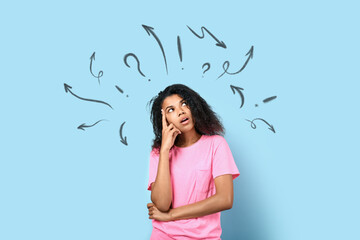 Thoughtful young African-American woman on light blue background