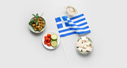 Flag of Greece with olives, oil, feta cheese and vegetables on light background