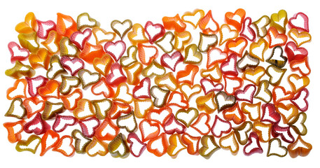 Colorful heart shaped pasta closeup on white background