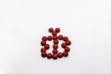 Red butterfly made of chocolate candies isolated on white background.