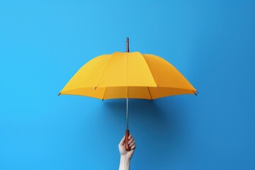 Hand holding yellow umbrella on blue background, Generative AI