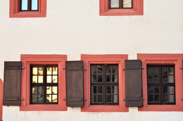 Fototapeta na wymiar View of old building with wooden windows and shutters