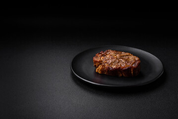 Delicious juicy pork or beef steak grilled with salt, spices and herbs