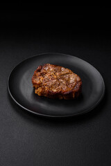 Delicious juicy pork or beef steak grilled with salt, spices and herbs