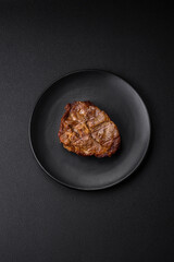 Delicious juicy pork or beef steak grilled with salt, spices and herbs