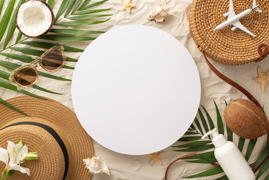 Island paradise getaway idea. Top view of miniature airplane model, purse, glasses, hat, sunscreen, seashells, starfish, palm leaves, and coconut on sandy beach, featuring empty circle for text or ad - Powered by Adobe