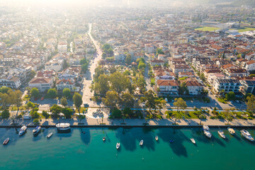 Fototapeta premium Aerial view of streets of Fethiye town on Aegean sea. Drone flying over the sea and the town