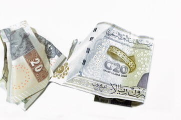 Crumpled Egyptian 20LE twenty pounds and Saudi Arabia money of 20 SAR twenty riyals with G20...