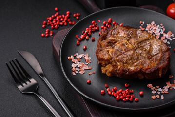 Delicious juicy pork or beef steak grilled with salt, spices and herbs