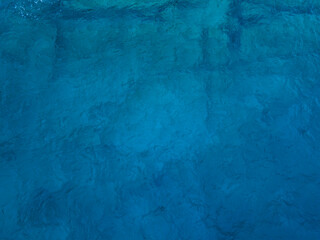 Aerial top down view of deep blue sea surface water, static shot