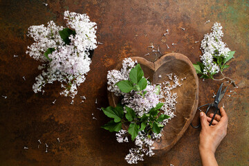 hands holding a lilac flower bunch 
