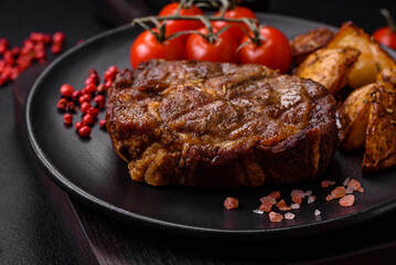 Delicious juicy pork or beef steak grilled with salt, spices and herbs
