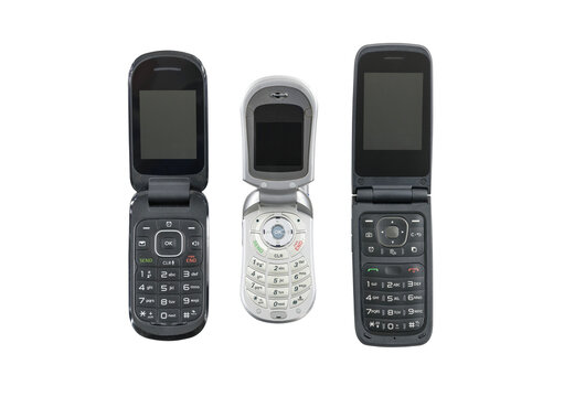 Three old flip cell phones isolated with cut out background.  
