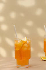 A glass of cold tea, ice cubes, lemon slices. Cooling summer drinks.