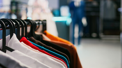 Diversity of formal clothes hanging in modern retail shop, empty clothing store or boutique filled with fashionable merchandise. Trendy modern store, small business concept. Close up. - obrazy, fototapety, plakaty