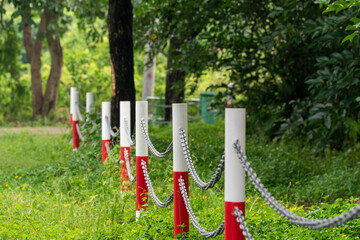 Old metal chain fence stanchion with chain fence in a country park